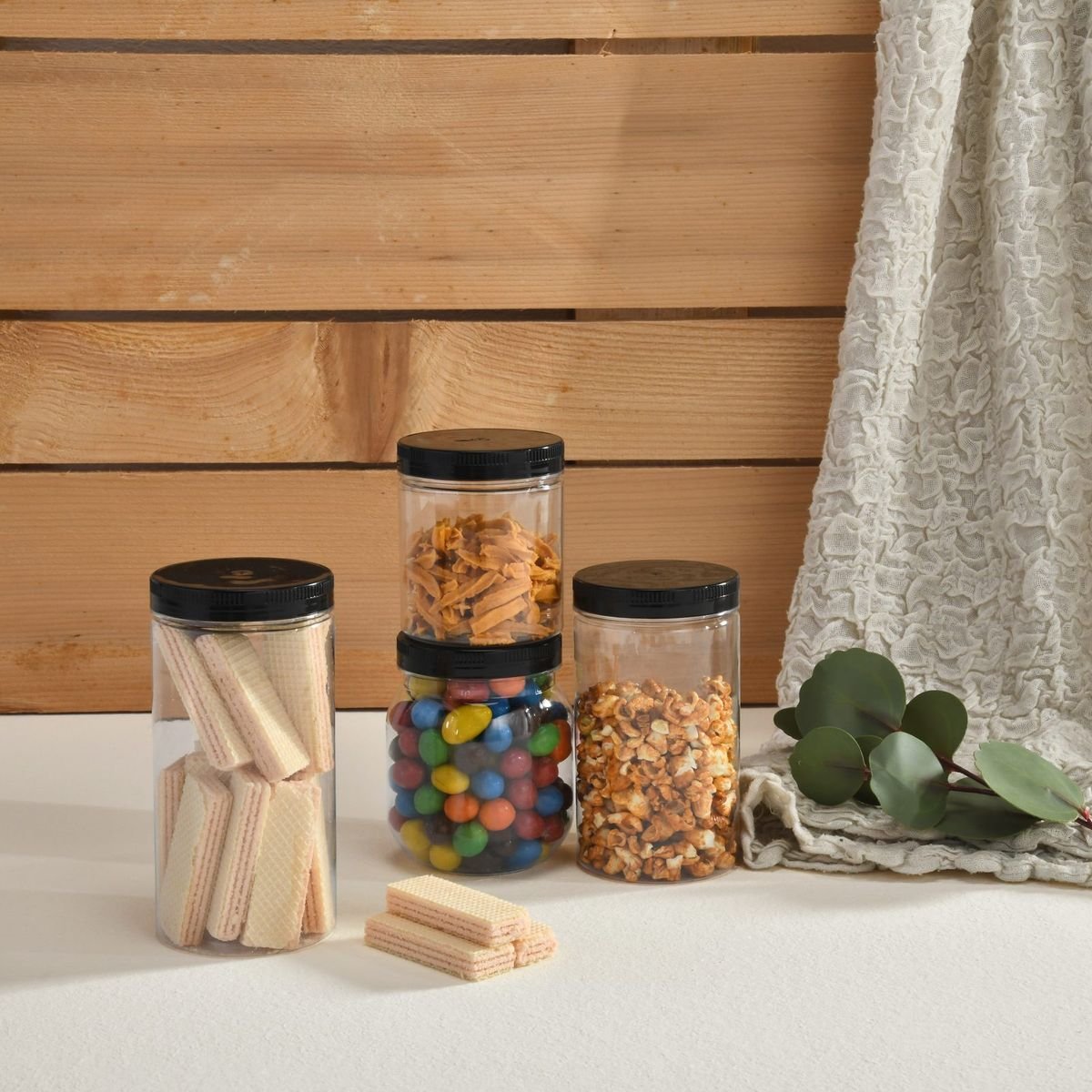 Jars with black caps filled with snacks
