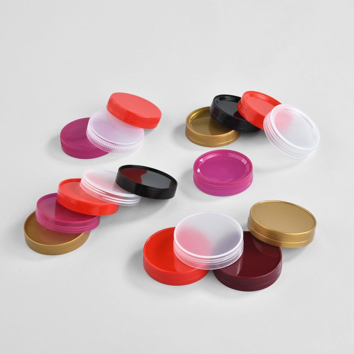 Caps in red, pink, gold and black